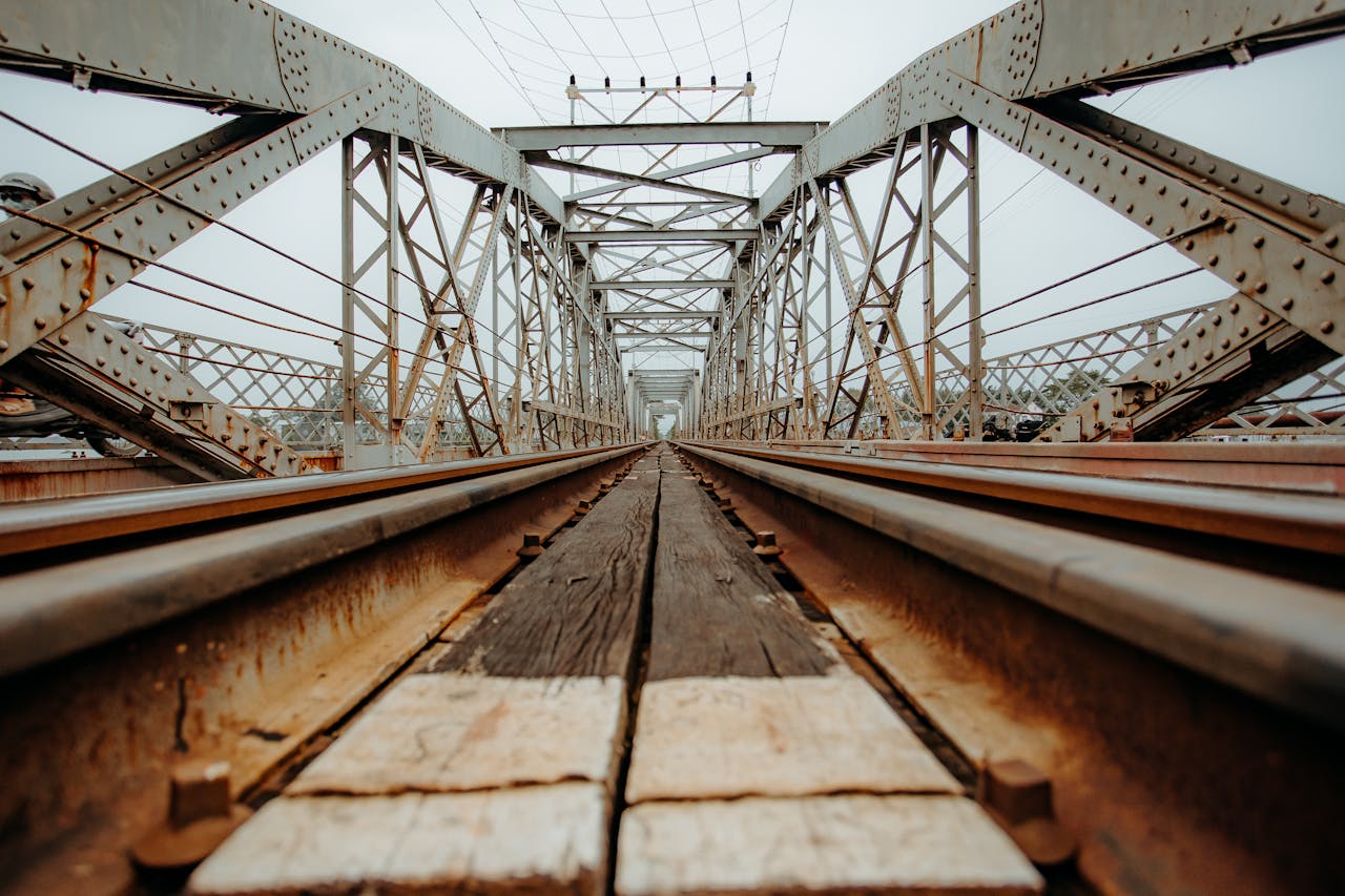 Close-up view of railway tracks on a steel bridge, capturing architectural details.